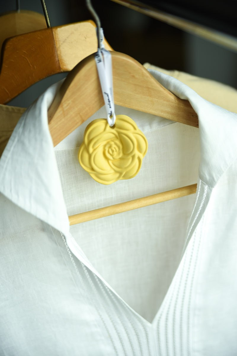 A rose-shaped sachet hanging in a wardrobe